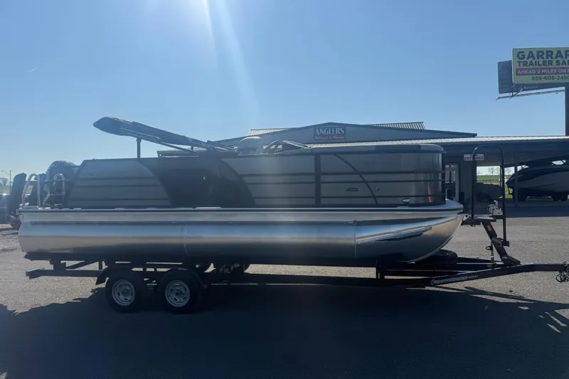 Slide: The Image of 2026 Trifecta 22ULCS pontoon boat on trailer under clear sky. - 2