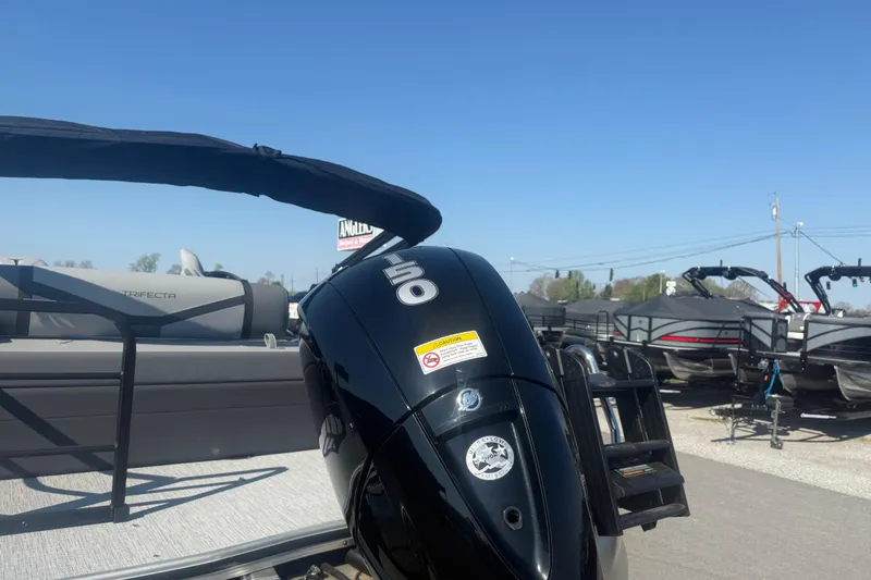 Slide: The Image of 2026 Trifecta 22ULCS pontoon boat with a 150 HP outboard motor, displayed outdoors. - 9