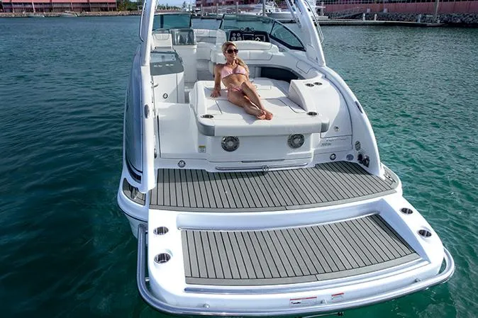 Slide: The Image of Manufacturer Provided Image: 2015 Formula 310 Bowrider with woman relaxing on the deck in a marina. - 5