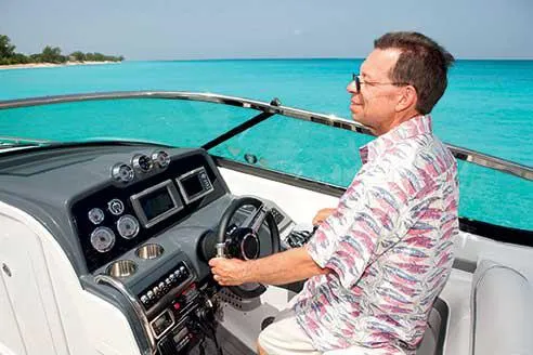 Slide: The Image of Manufacturer Provided Image: Man piloting 2015 Formula 310 Bowrider on clear turquoise waters. - 8