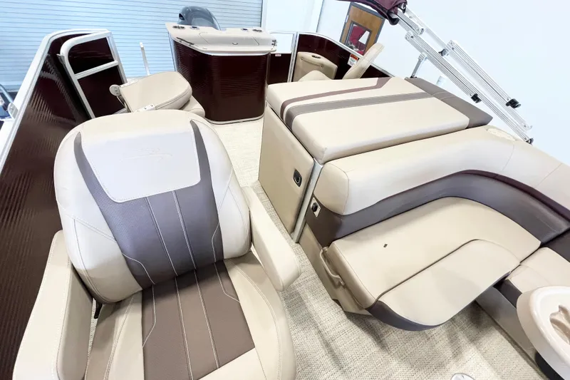 Slide: The Image of 2020 Bennington SX25 boat interior with beige and brown seating, showcasing luxury and comfort. - 10