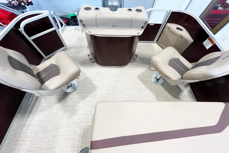 Slide: The Image of 2020 Bennington SX25 boat interior with beige seating and helm station. - 11