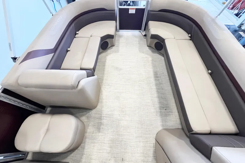 Slide: The Image of 2020 Bennington SX25 pontoon boat interior with beige seating and carpet flooring. - 13