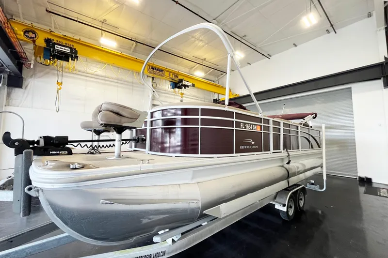 Slide: The Image of 2020 Bennington SX25 pontoon boat on trailer in indoor storage facility. - 3