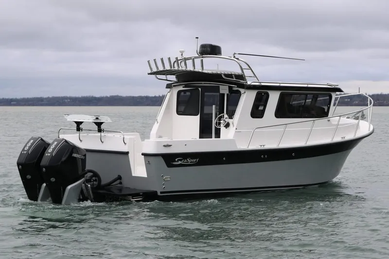 The Image of 2026 Seaport Commander 2800 boat on water, featuring dual Mercury engines. - 1