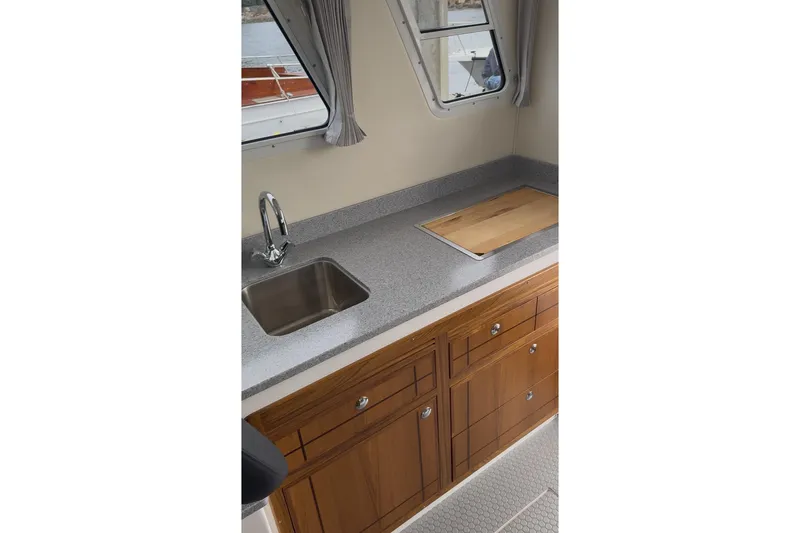 Slide: The Image of Modern kitchen area in 2026 Seaport Commander 2800 boat, featuring sleek countertop and wooden cabinetry. - 11