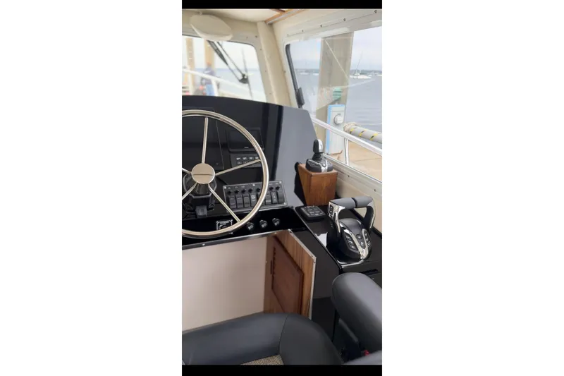 Slide: The Image of Interior helm of 2026 Seaport Commander 2800 boat with steering wheel and controls. - 14