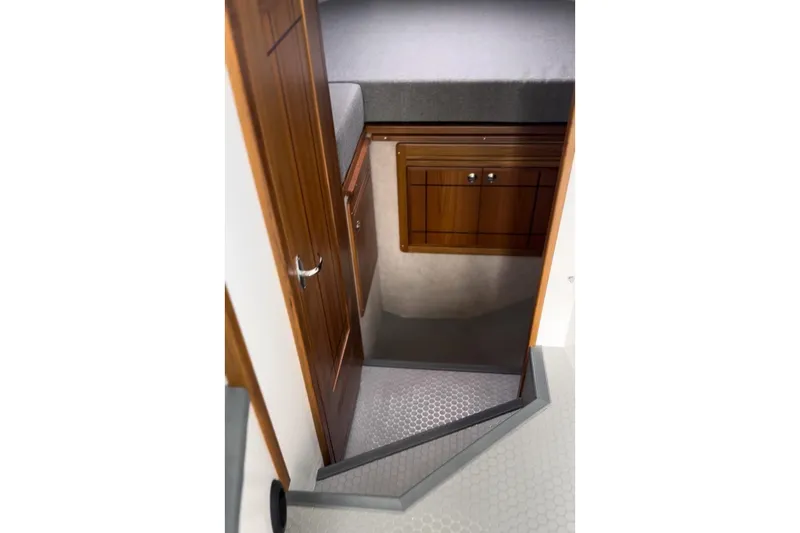 Slide: The Image of Interior cabin view of 2026 Seaport Commander 2800, featuring wooden cabinetry and stairs. - 15