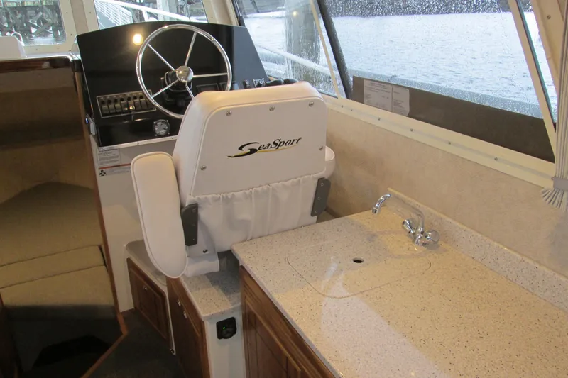 Slide: The Image of Interior of 2026 Seaport Commander 2800 boat with helm and kitchenette area. - 17