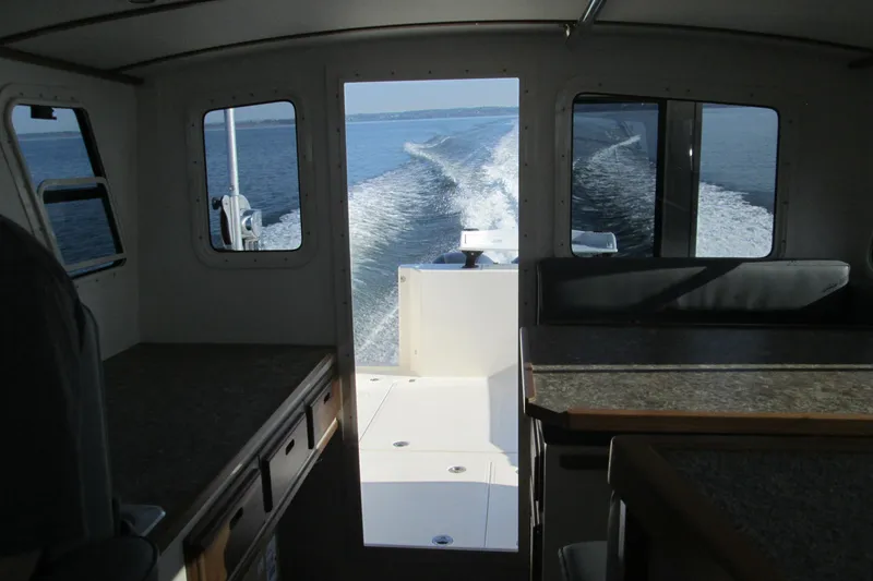 Slide: The Image of Interior view of Seaport Commander 2800 boat, 2026 model, cruising on open water. - 26