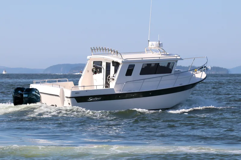 Slide: The Image of 2026 Seaport Commander 2800 boat cruising on open water with twin Mercury engines. - 5