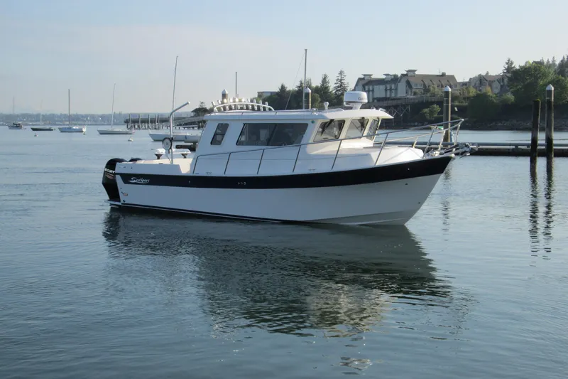 Slide: The Image of 2026 Seaport Commander 2800 boat docked in a serene marina setting. - 6