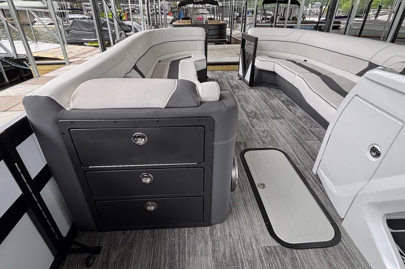 Slide: The Image of 2026 Viaggio D26U boat interior with sleek seating and storage drawers at a marina. - 33