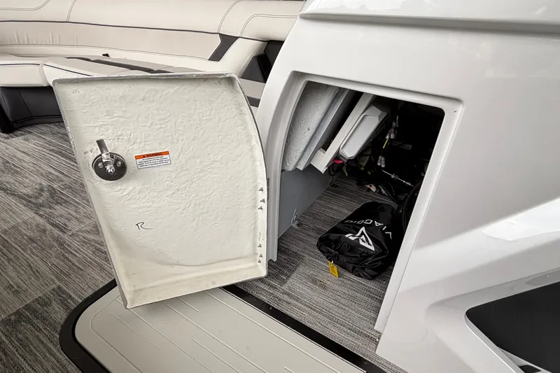 Slide: The Image of Open storage compartment in 2026 Viaggio D26U boat, revealing interior equipment and bag. - 39