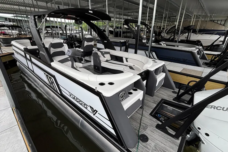 Slide: The Image of 2026 Viaggio D26U pontoon boat docked, featuring sleek design and modern seating arrangement. - 49
