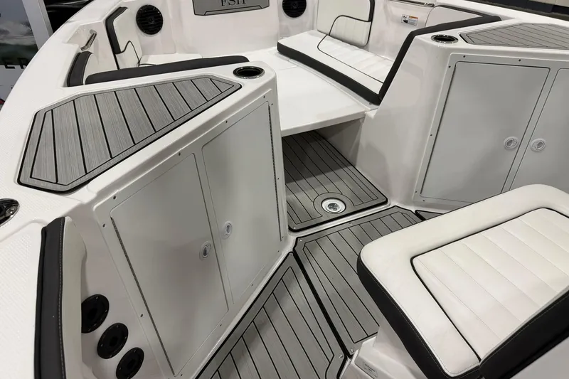 Slide: The Image of 2025 Yamaha Boats 222 FSH Sport E interior with sleek seating and storage compartments. - 11
