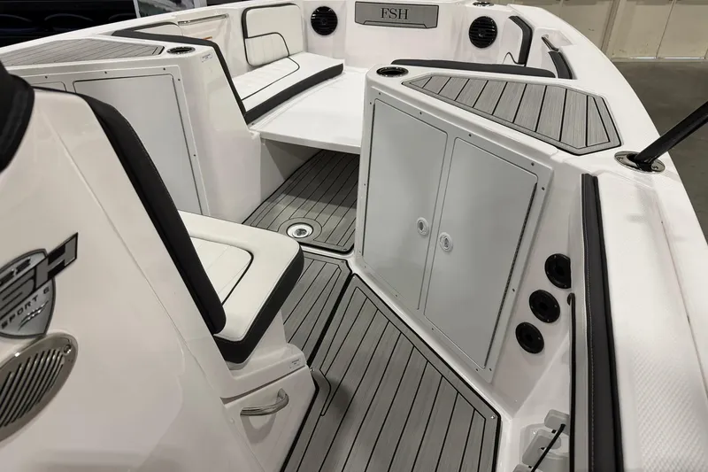 Slide: The Image of 2025 Yamaha Boats 222 FSH Sport E interior with seating and storage compartments. - 12