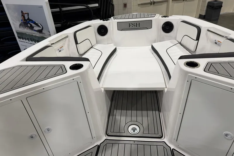 Slide: The Image of 2025 Yamaha Boats 222 FSH Sport E interior with seating and storage compartments. - 14