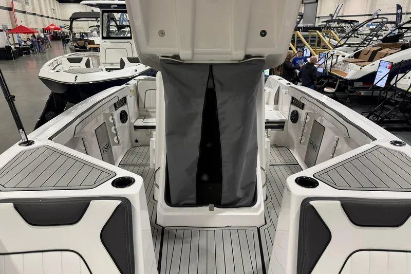 Slide: The Image of 2025 Yamaha Boats 222 FSH Sport E interior at a boat show, showcasing seating and storage. - 19