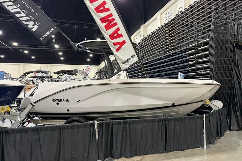 Slide: The Image of 2025 Yamaha Boats 222 FSH Sport E displayed at a boat show. - 2