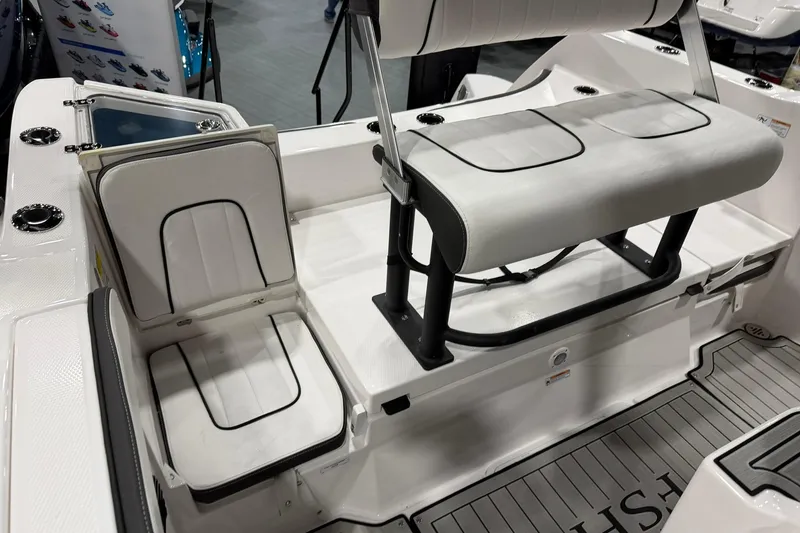 Slide: The Image of 2025 Yamaha Boats 222 FSH Sport E interior seating with white cushioned seats and black accents. - 23