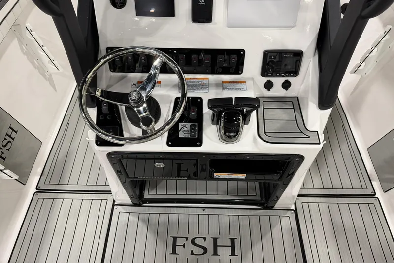 Slide: The Image of 2025 Yamaha Boats 222 FSH Sport E dashboard with steering wheel and controls. - 25