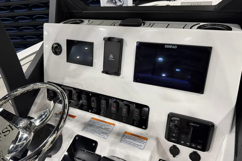 Slide: The Image of 2025 Yamaha Boats 222 FSH Sport E dashboard with Simrad display and controls. - 26