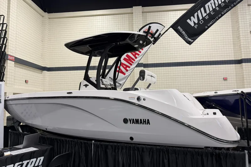 Slide: The Image of 2025 Yamaha Boats 222 FSH Sport E displayed indoors, showcasing sleek design and modern features. - 3