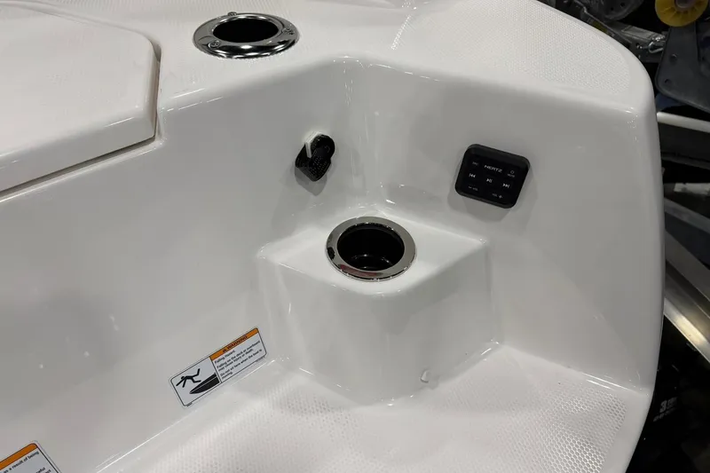 Slide: The Image of Interior detail of 2025 Yamaha Boats 222 FSH Sport E, featuring cup holder and control panel. - 5