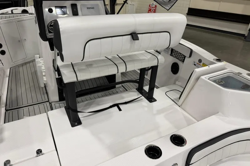 Slide: The Image of 2025 Yamaha Boats 222 FSH Sport E interior with white seating and modern dashboard. - 7