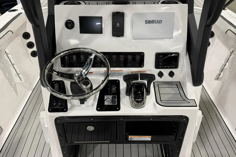 Slide: The Image of 2025 Yamaha Boats 222 FSH Sport E dashboard with steering wheel and controls. - 8