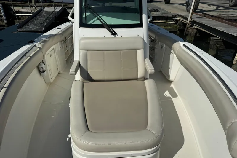 Slide: The Image of 2020 Boston Whaler 280 Outrage boat interior with cushioned seating and armrests. - 10