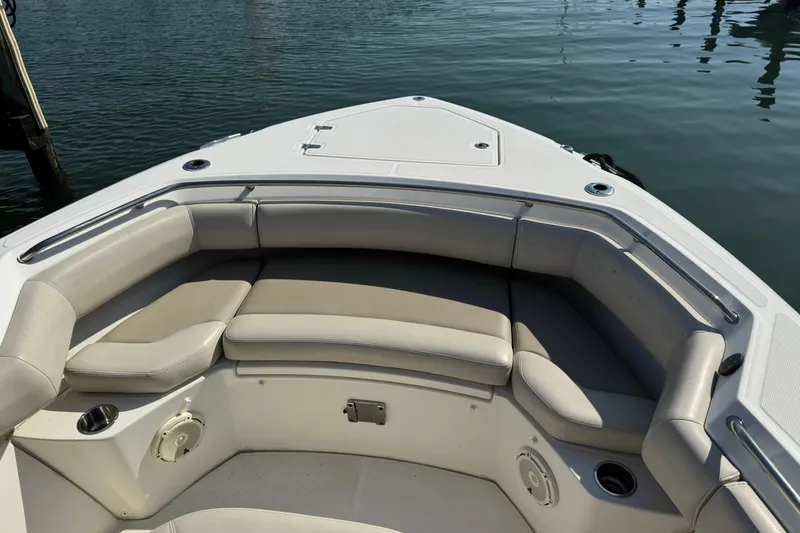 Slide: The Image of 2020 Boston Whaler 280 Outrage boat interior with cushioned seating and cup holders. - 11