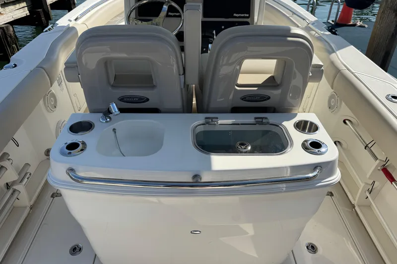 Slide: The Image of 2020 Boston Whaler 280 Outrage boat interior with seating and console features. - 12