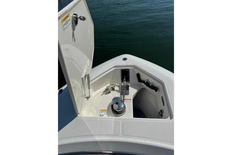 Slide: The Image of 2020 Boston Whaler 280 Outrage anchor compartment open on calm water. - 13