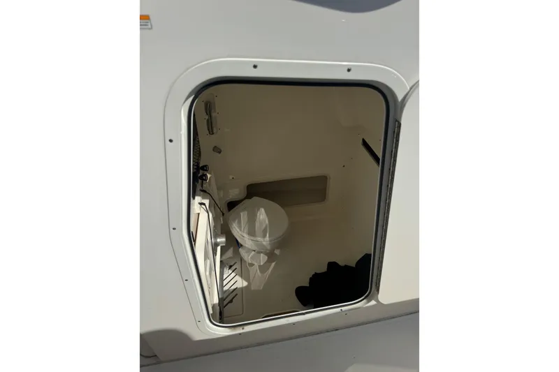 Slide: The Image of Interior view of 2020 Boston Whaler 280 Outrage boat's compact bathroom. - 14