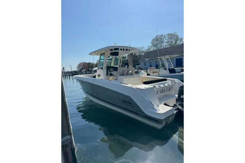 Slide: The Image of 2020 Boston Whaler 280 Outrage boat docked in calm waters. - 2