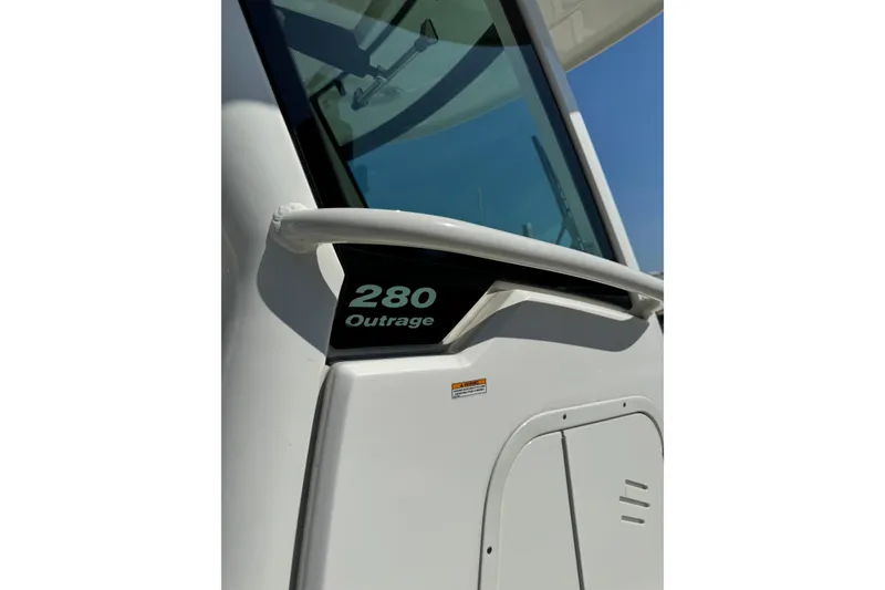 Slide: The Image of 2020 Boston Whaler 280 Outrage boat detail with window and railing. - 21