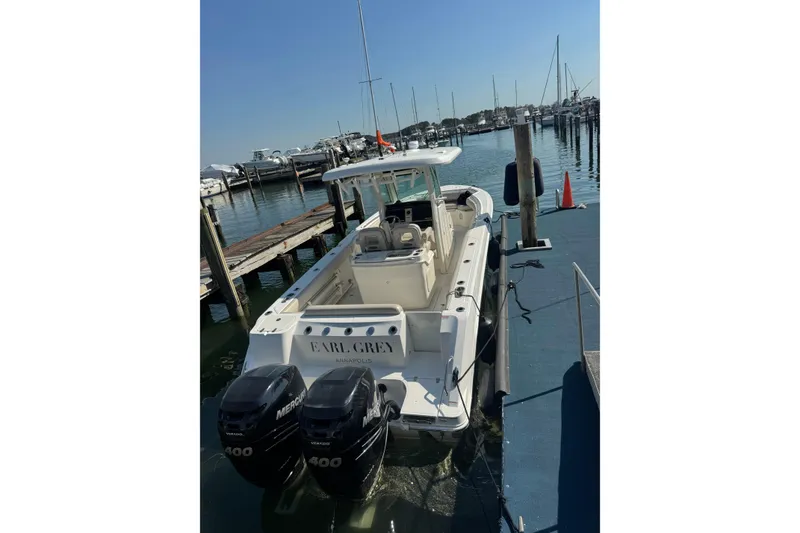 Slide: The Image of 2020 Boston Whaler 280 Outrage docked, featuring twin Mercury 400 engines. - 3