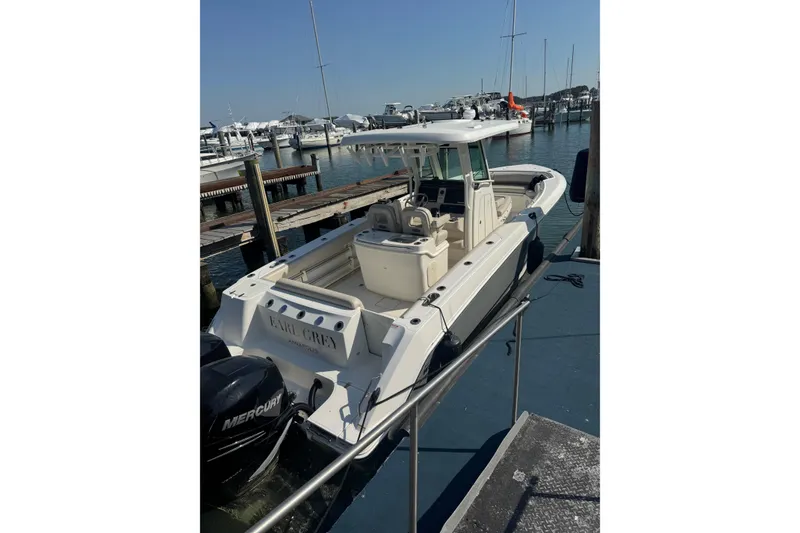 Slide: The Image of 2020 Boston Whaler 280 Outrage docked at a marina with Mercury engines. - 4