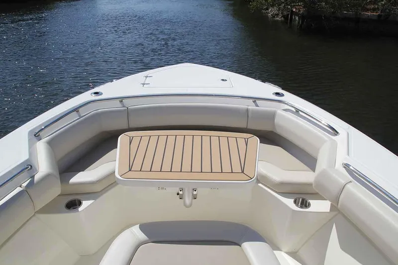 Slide: The Image of Manufacturer Provided Image: 2020 Boston Whaler 280 Outrage boat bow seating area with table on calm water. - 5