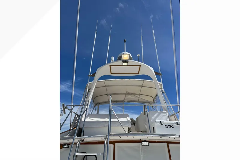 Slide: The Image of 1971 Pacifica 44 Convertible yacht with antennas against a clear blue sky. - 10