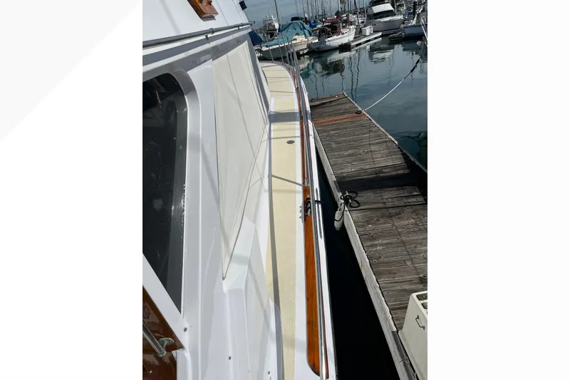 Slide: The Image of 1971 Pacifica 44 Convertible yacht docked at a marina, showcasing sleek design and craftsmanship. - 11