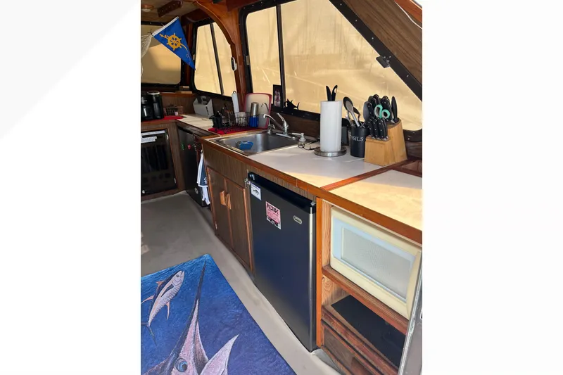Slide: The Image of 1971 Pacifica 44 Convertible yacht ladder and deck area with sink and storage. - 15