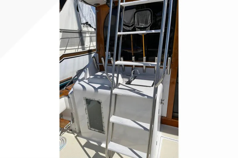 Slide: The Image of 1971 Pacifica 44 Convertible yacht deck with fishing rod holders and storage compartment. - 16