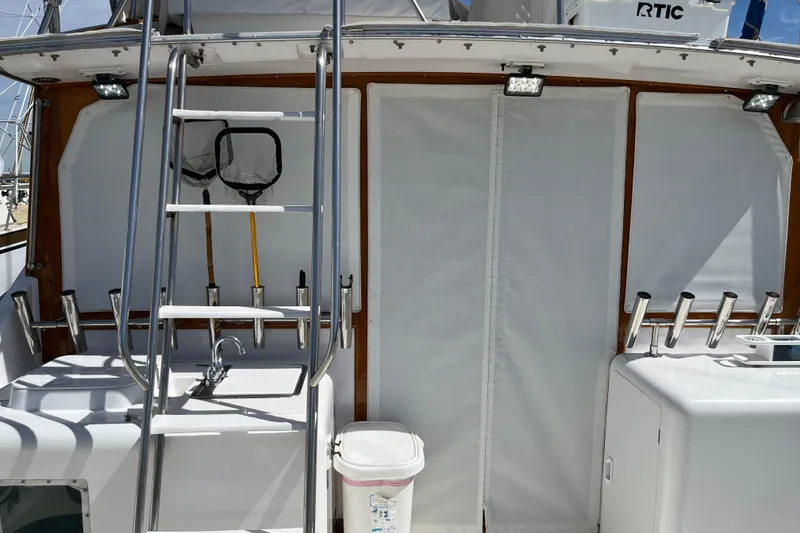 Slide: The Image of 1971 Pacifica 44 Convertible boat deck with ladder, fishing nets, and rod holders. - 18