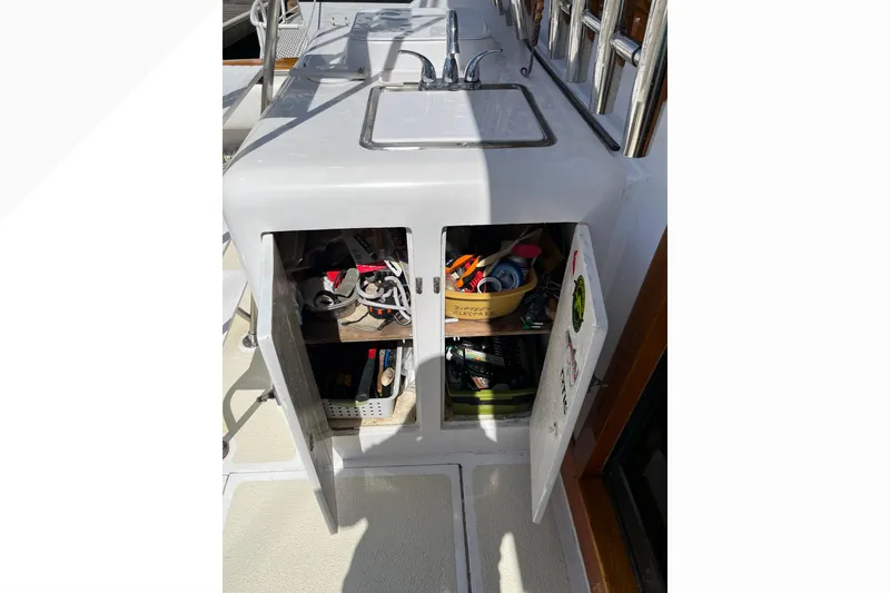Slide: The Image of Open cabinet with tools and supplies on a 1971 Pacifica 44 Convertible boat. - 20