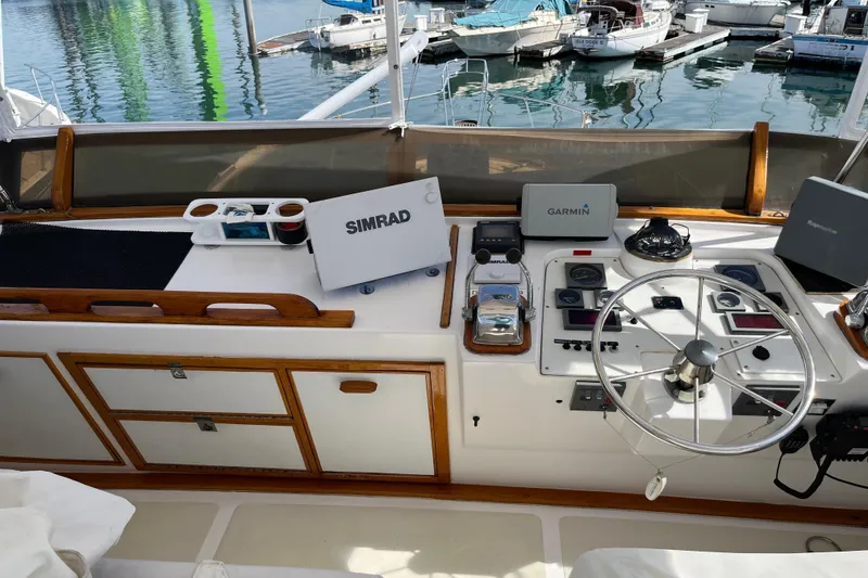 Slide: The Image of 1971 Pacifica 44 Convertible yacht helm with navigation equipment and marina view. - 25