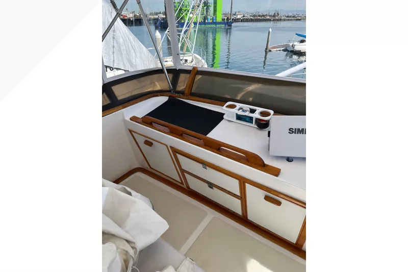 Slide: The Image of 1971 Pacifica 44 Convertible boat interior with wooden cabinetry and marina view. - 29