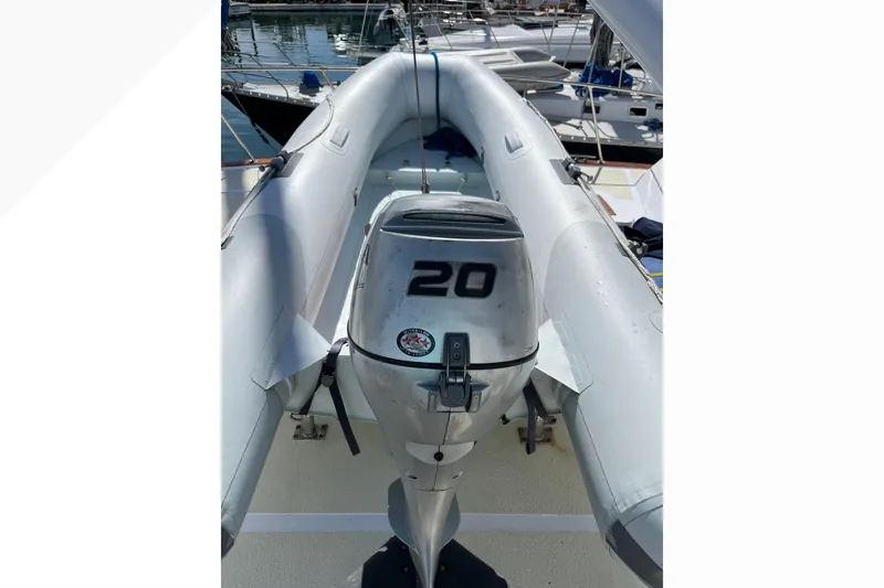 Slide: The Image of Inflatable boat with a 20 HP outboard motor, docked near Pacifica 44 Convertible, 1971. - 32